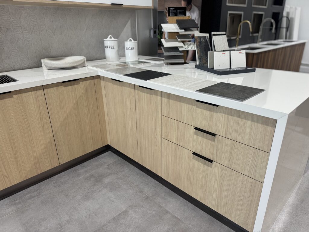 Light wood cabinetry and pale stone countertops